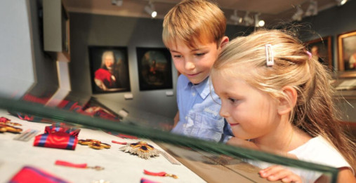 Zwei Kinder betrachten eine Vitrine